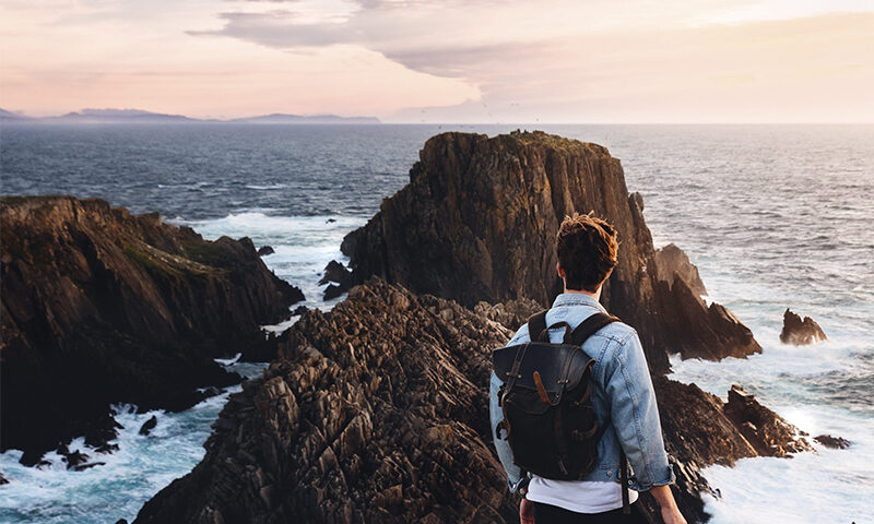 Man looking out at cliffs