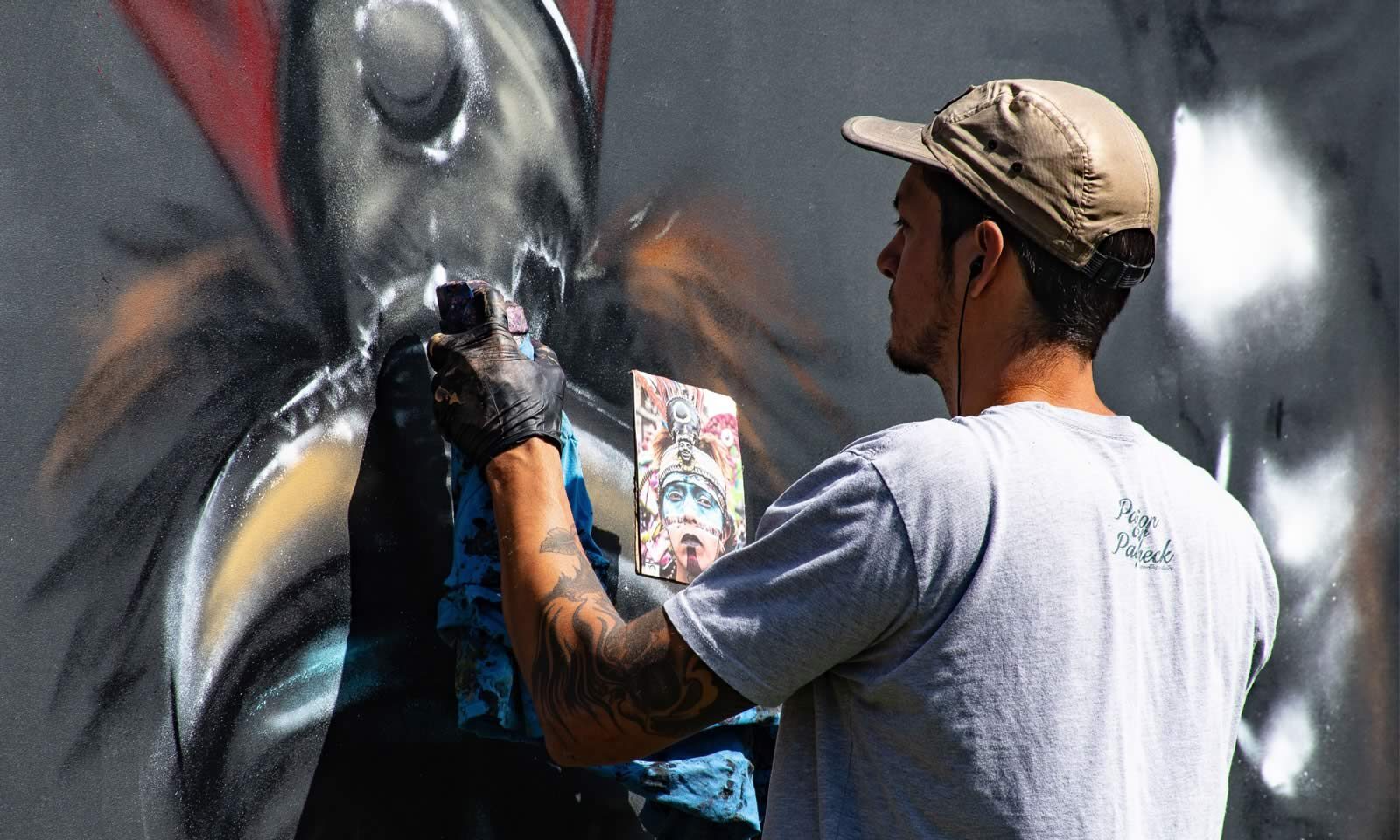 man spray painting